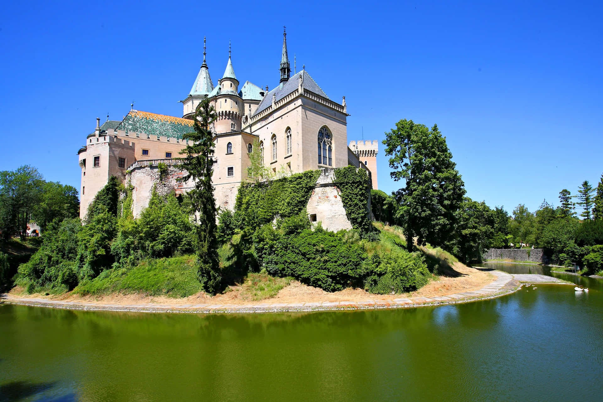 Captivating View Of Bojnice Castle Surrounded By Water