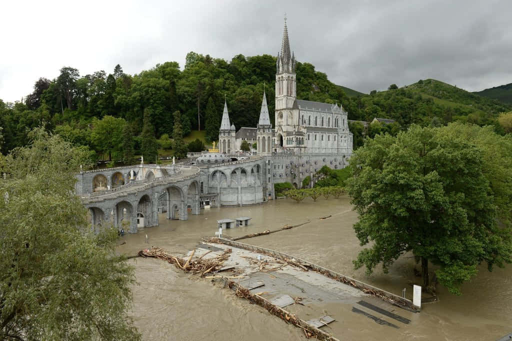 Captivating View Of Lourdes Sanctuary In France Background