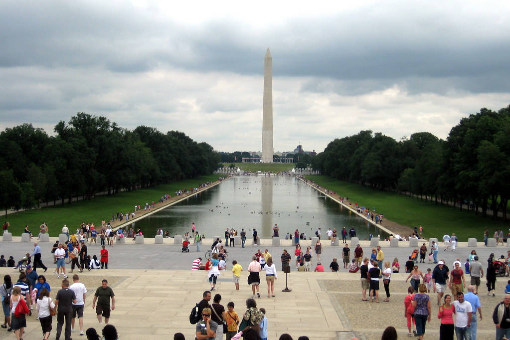 Captivating View Of The Washington Monument Surrounded By Tourists