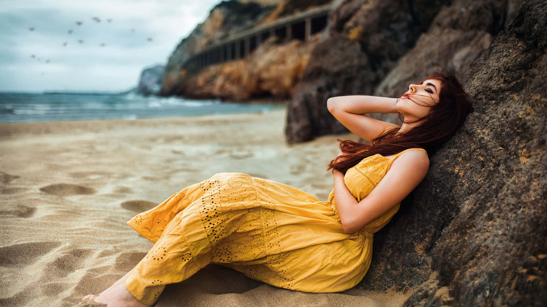 Captivating Woman Gazing At The Horizon On A Beach Background