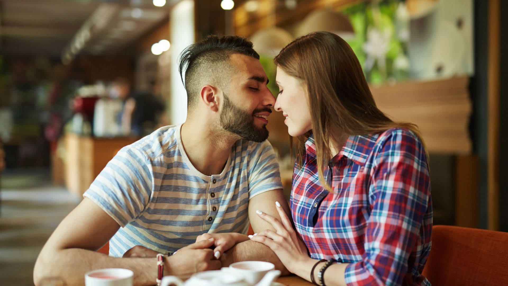 Capture The Romance: Sweet Couple Showcasing Attraction Background