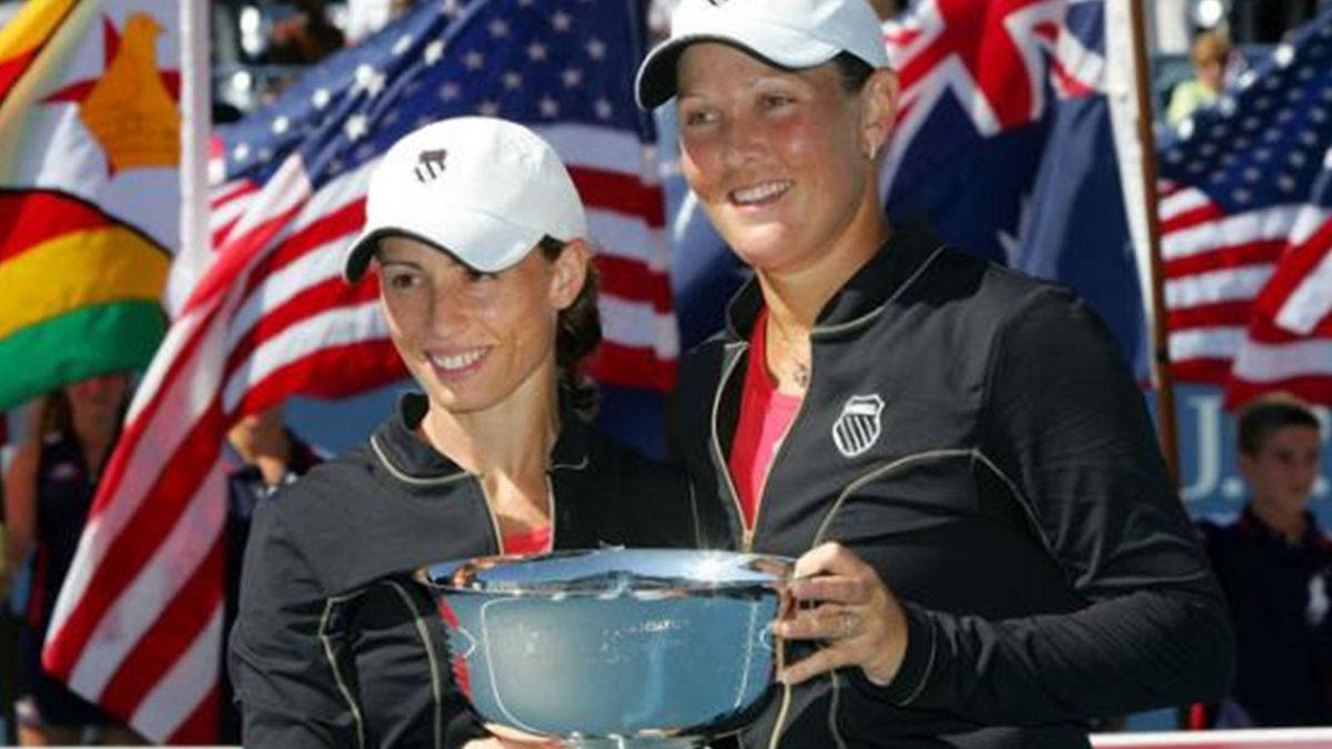 Cara Black Celebrating Victory With Trophy Background