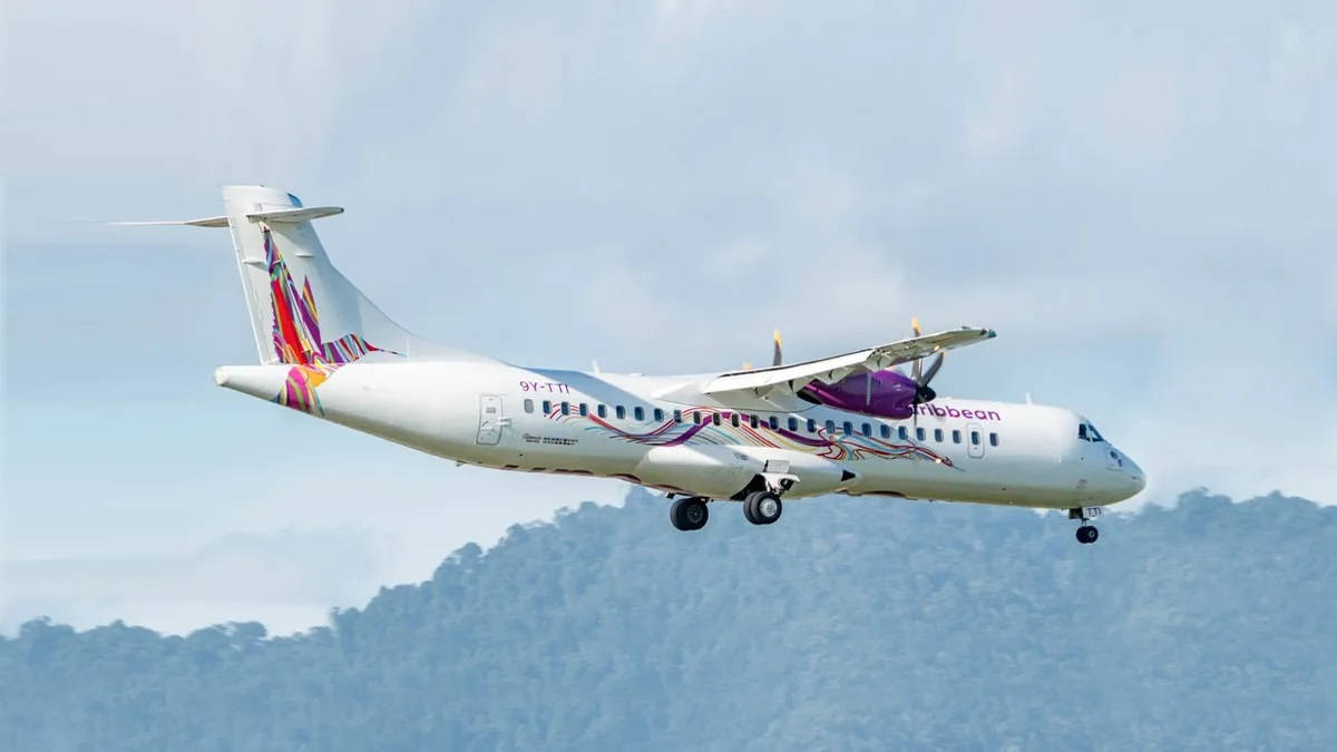 Caribbean Airlines Flying Above Mountain Trees