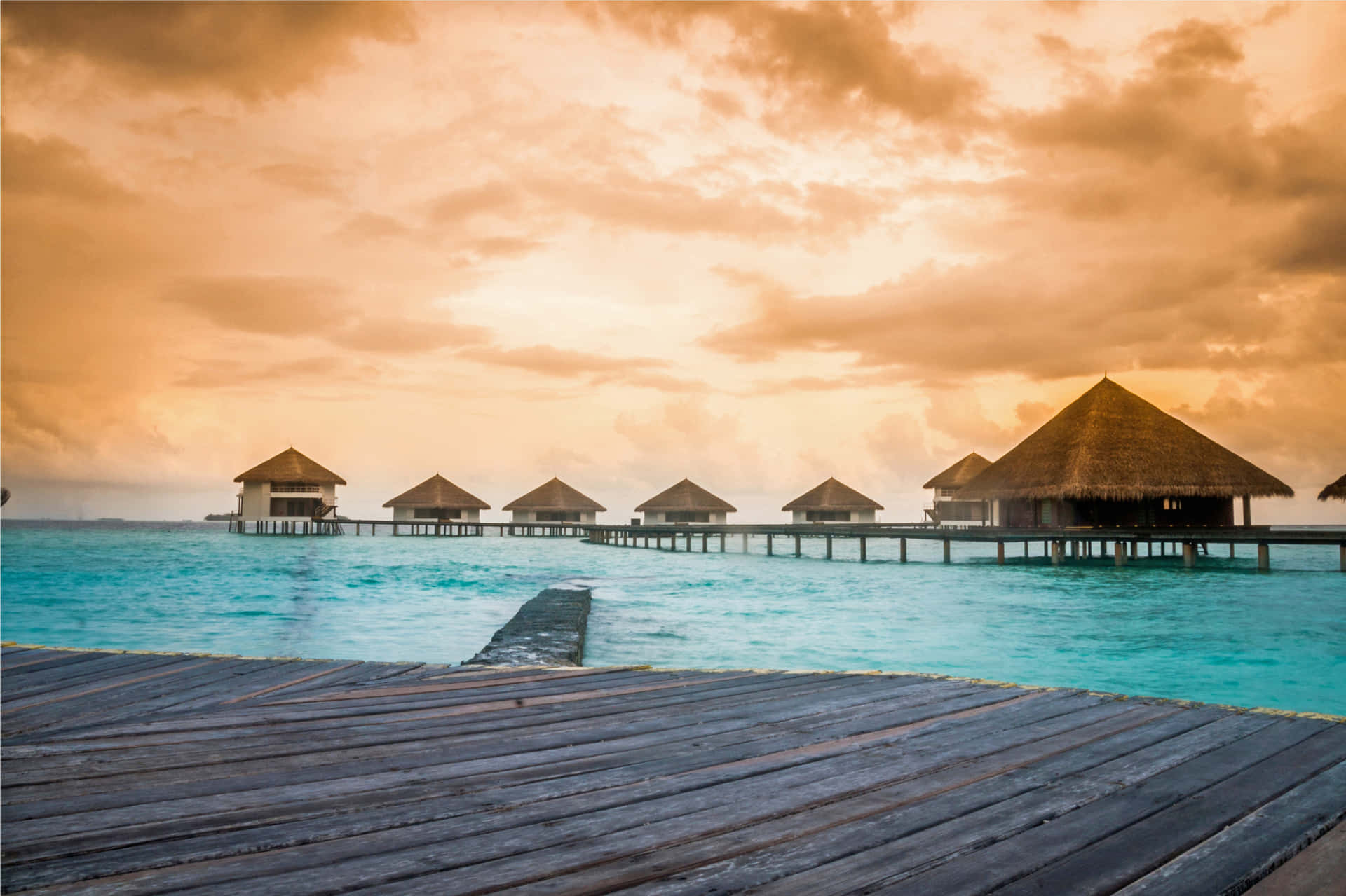 Caribbean Overwater Bungalowsat Sunset Background