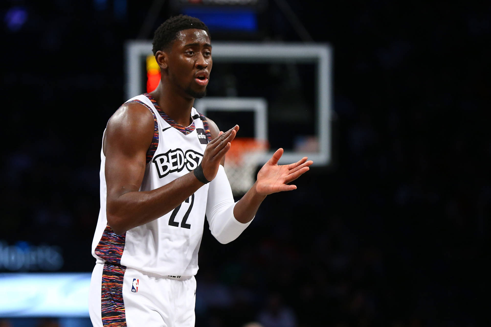 Caris Levert Energetically Clapping On The Basketball Court Background