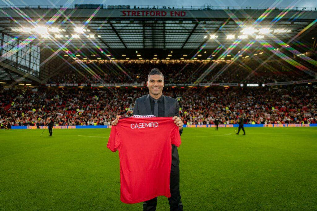 Carlos Casimiro Holding Red Shirt