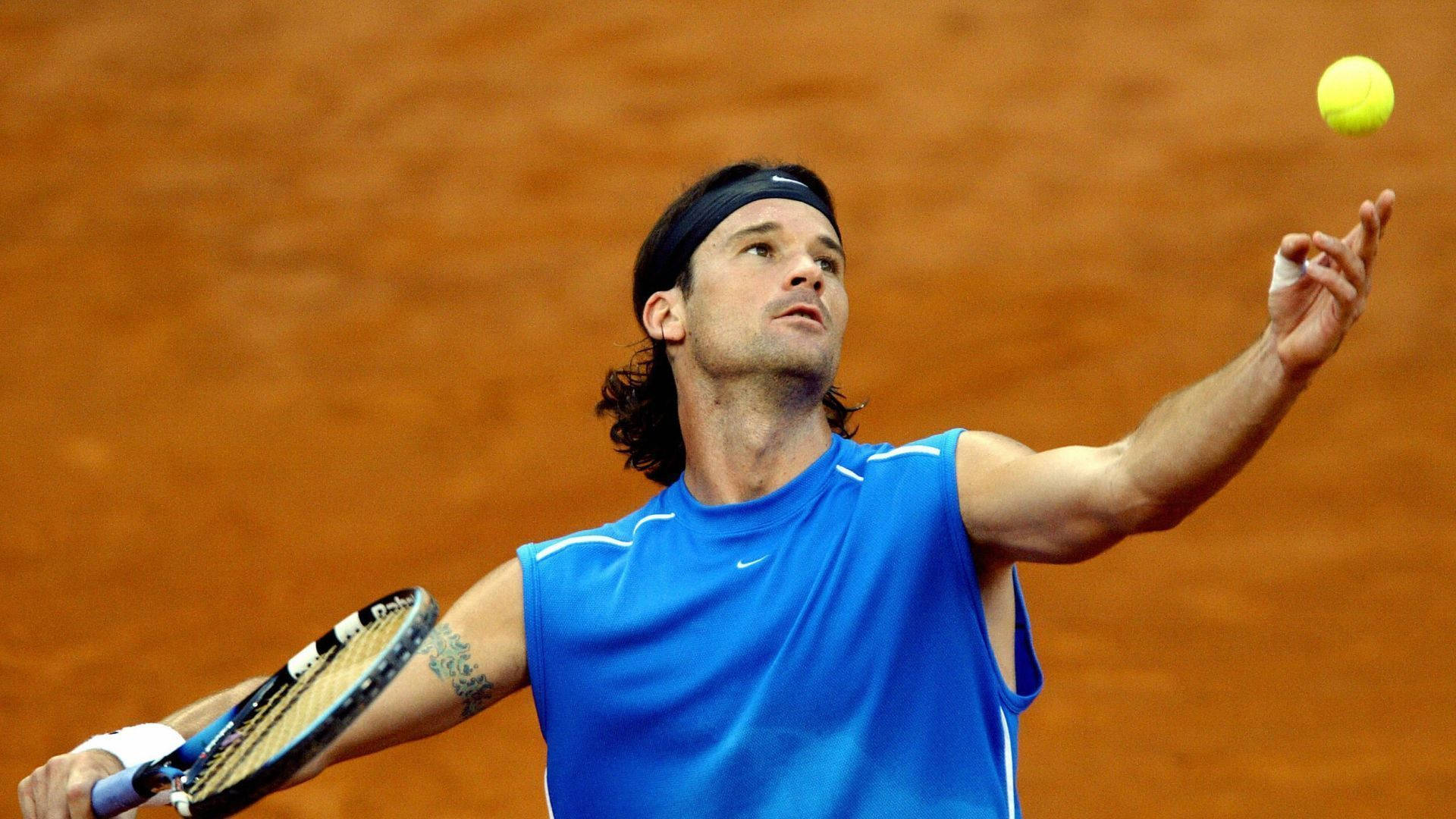 Carlos Moya Expertly Delivering A Tennis Serve Background