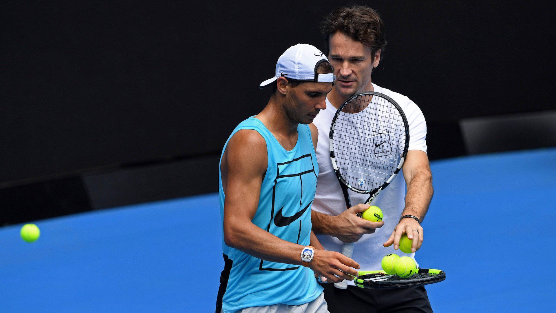 Carlos Moya Giving Balls To Nadal Background