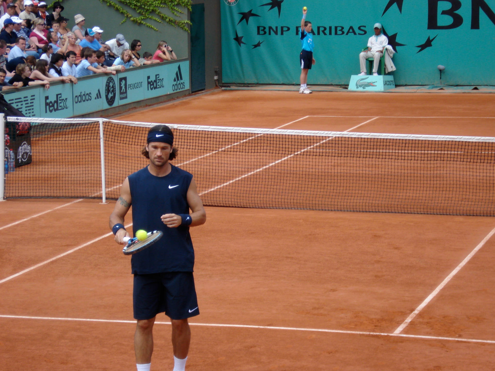 Carlos Moya In Clay Court Background