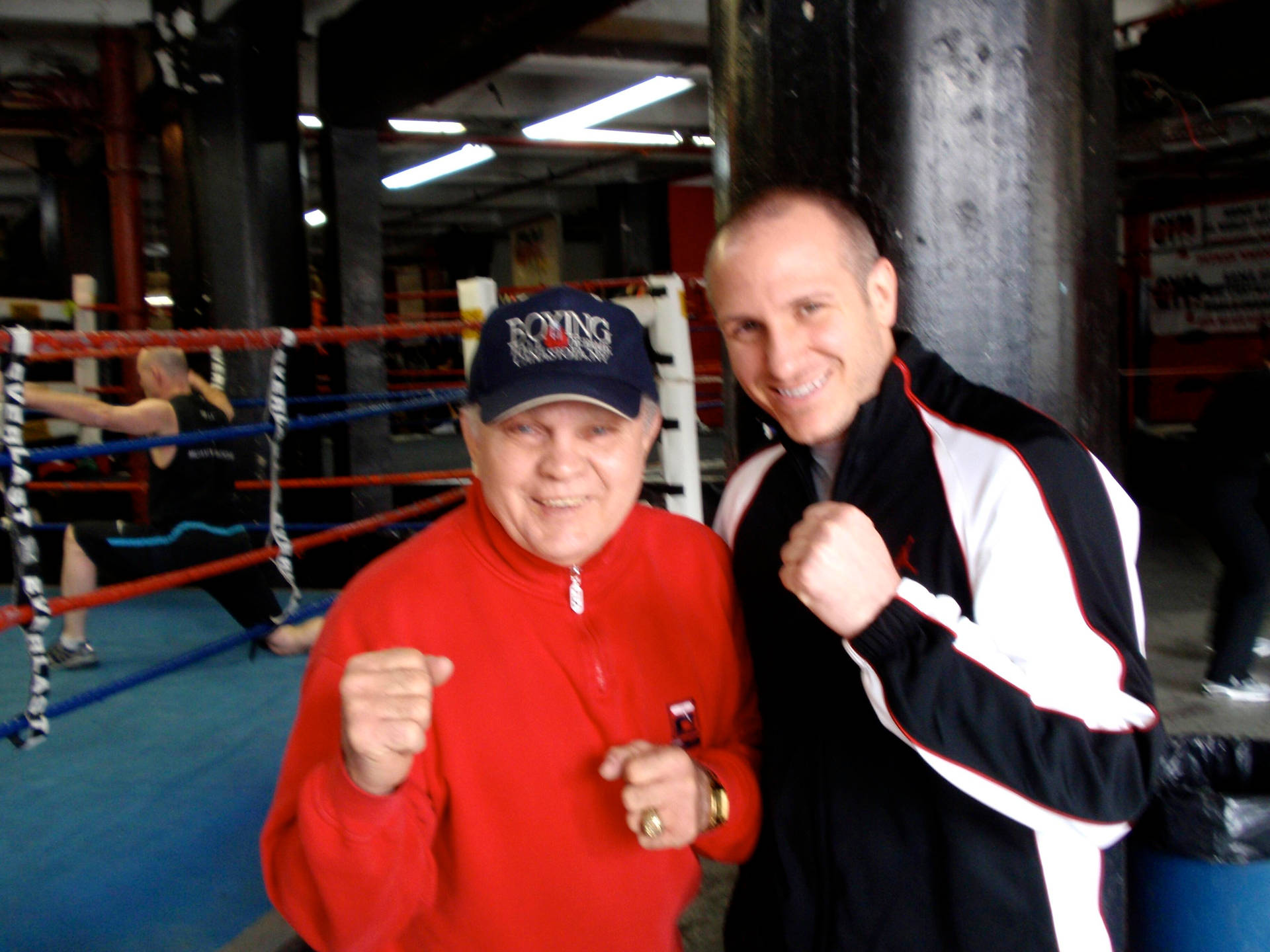 Carlos Ortiz With Fan Doing Fist Poses Background