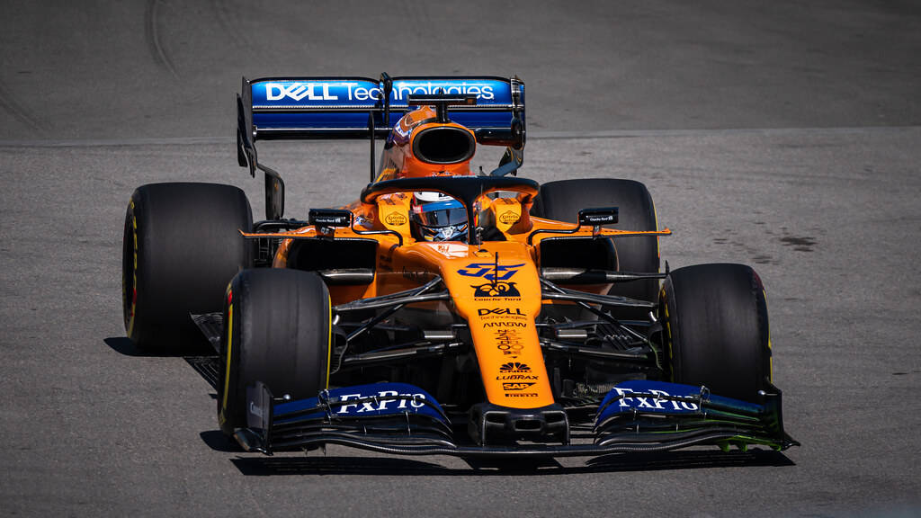 Carlos Sainz Jr Piloting Mclaren F1 Race Car Background