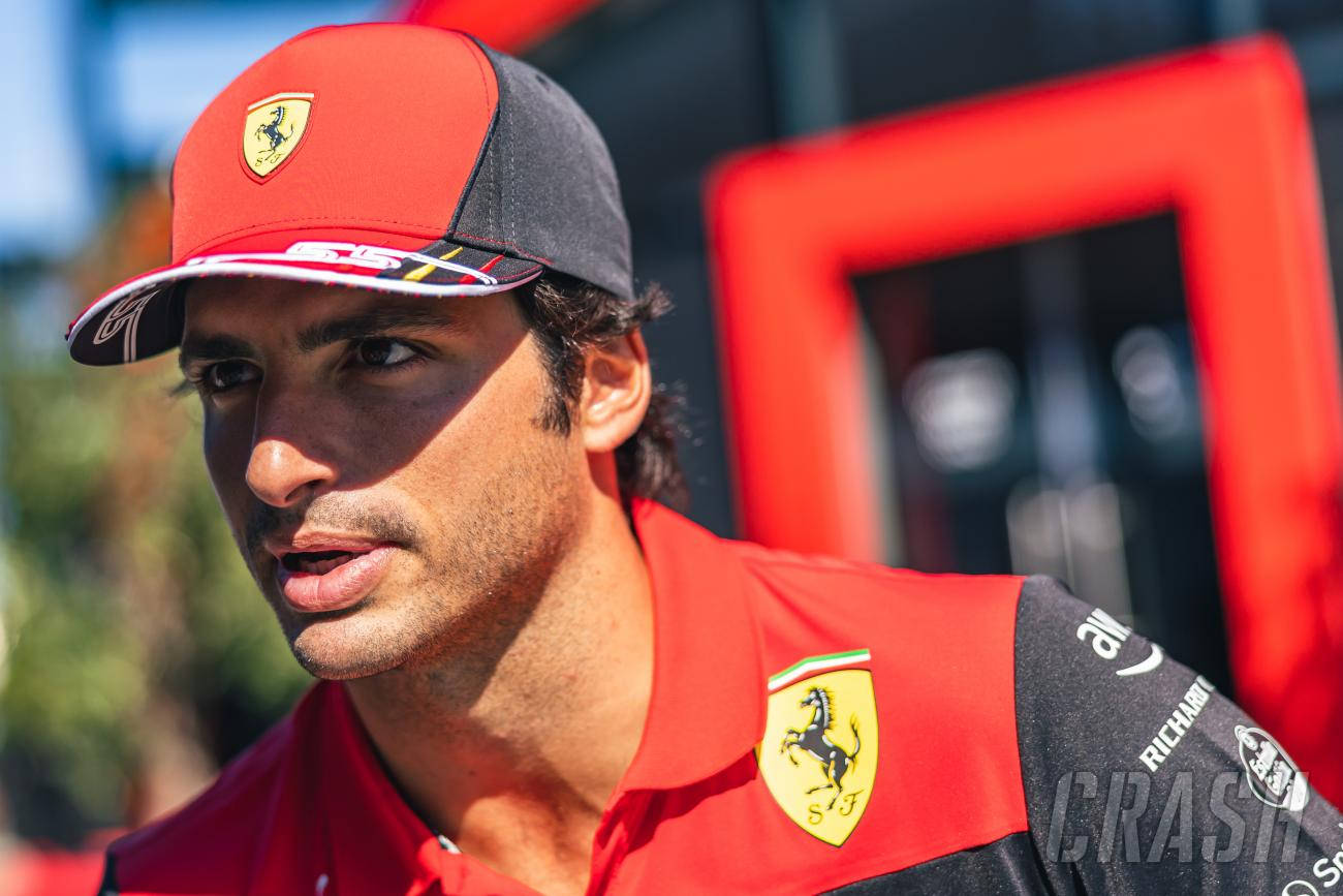 Carlos Sainz Jr. Wearing A Cap Background