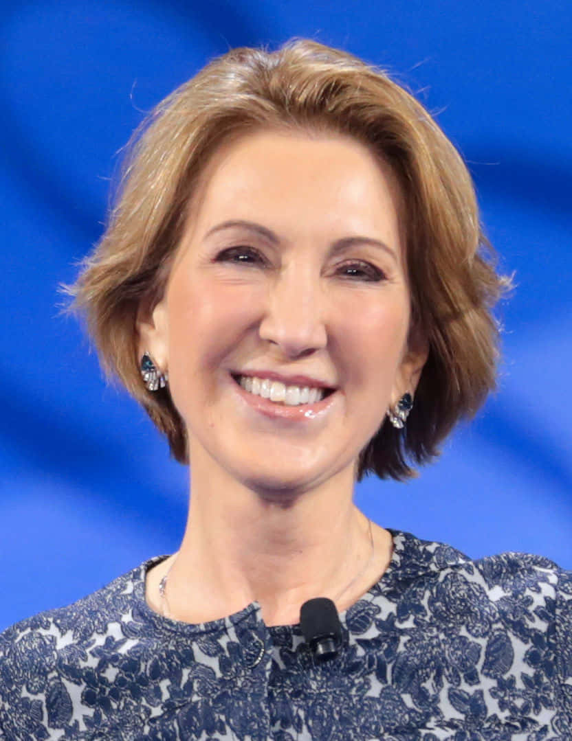 Carly Fiorina Smiling With Black Earrings Background