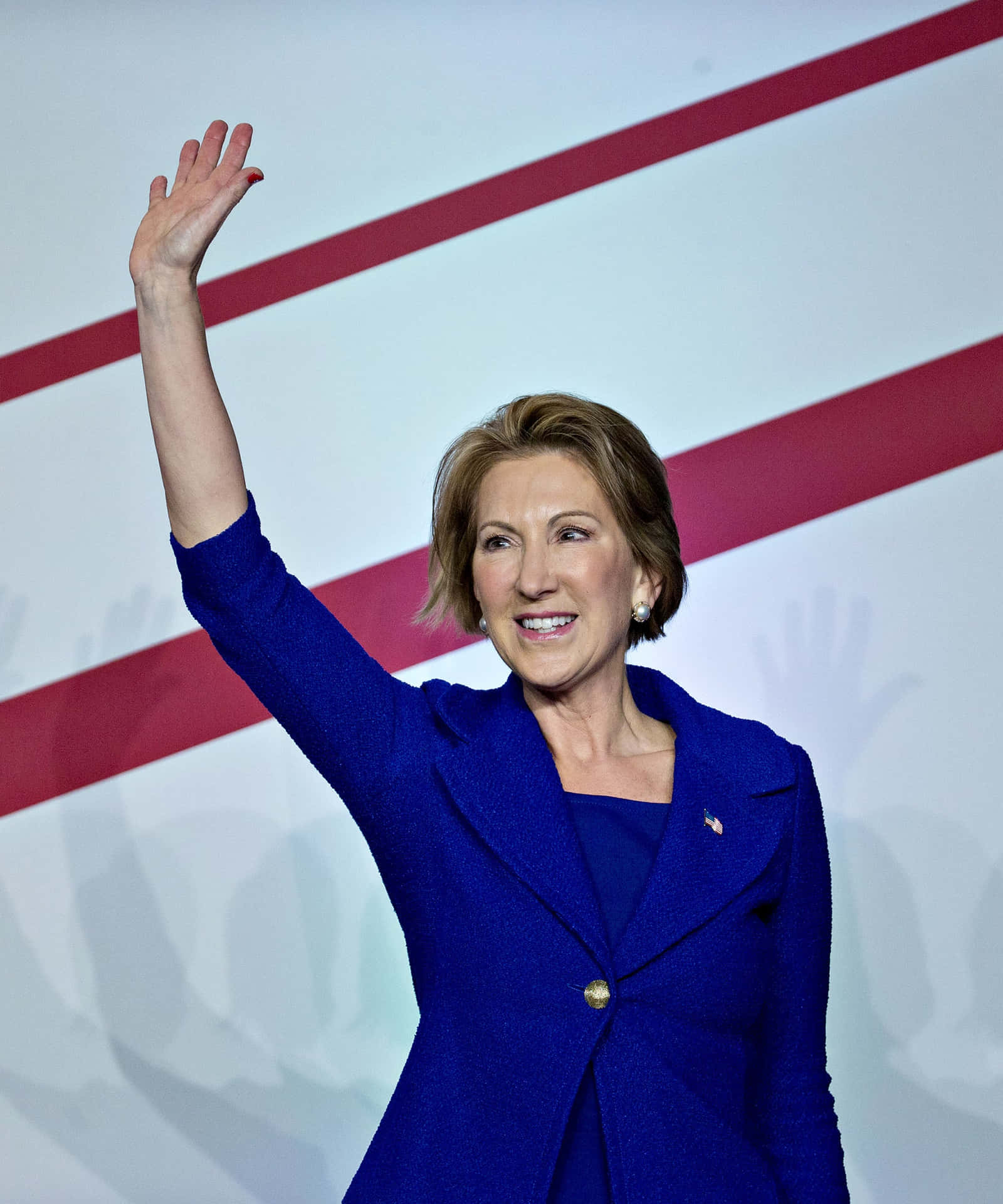 Carly Fiorina Waving While On Stage Background