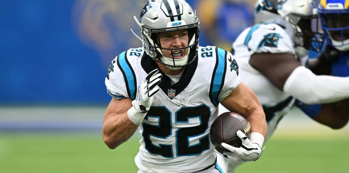 Carolina Panthers Running Back Christian Mccaffrey Rushes For A Touchdown During An Nfl Game. Background