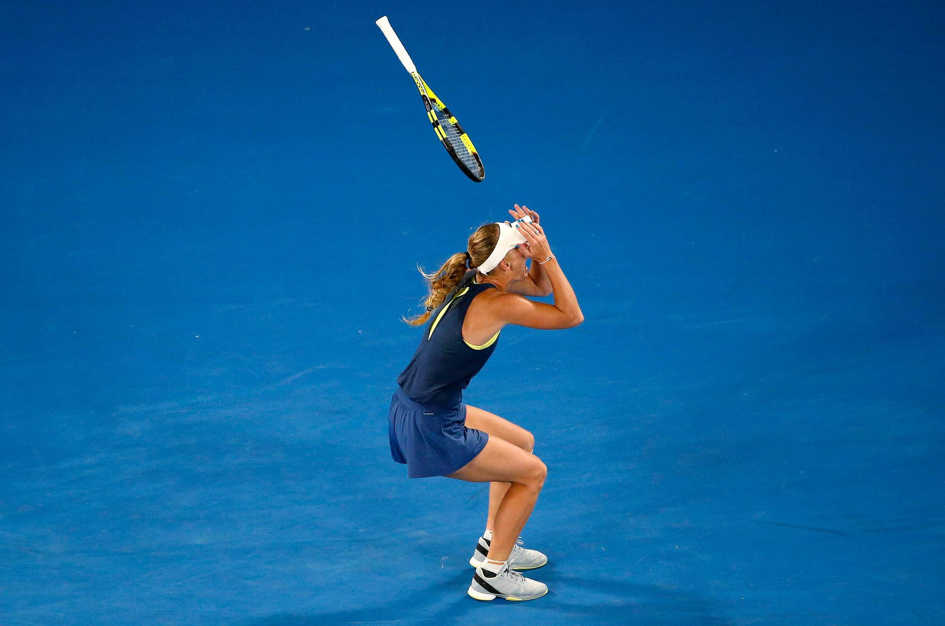 Caroline Wozniacki On Blue Tennis Court Background