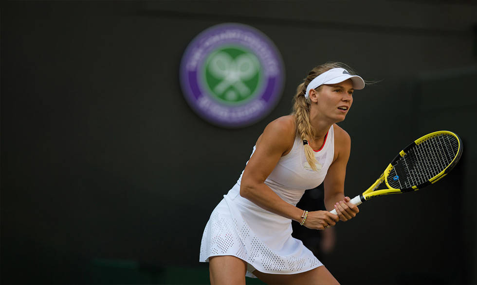 Caroline Wozniacki With Yellow Tennis Racket Background