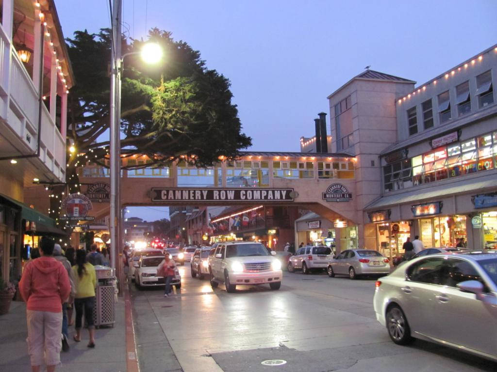 Cars Passing Cannery Row At Night Background