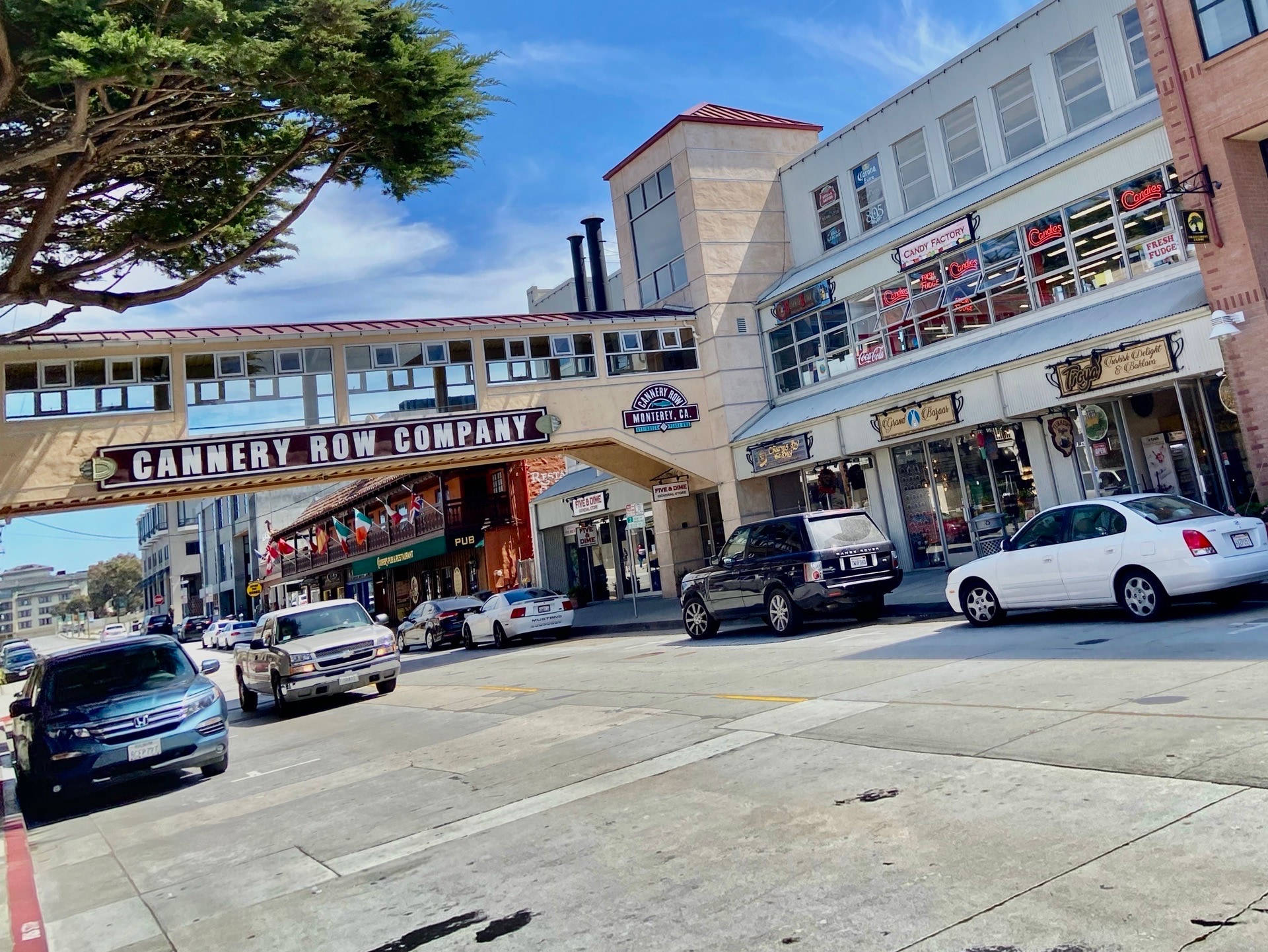 Cars Passing Through Cannery Row Background