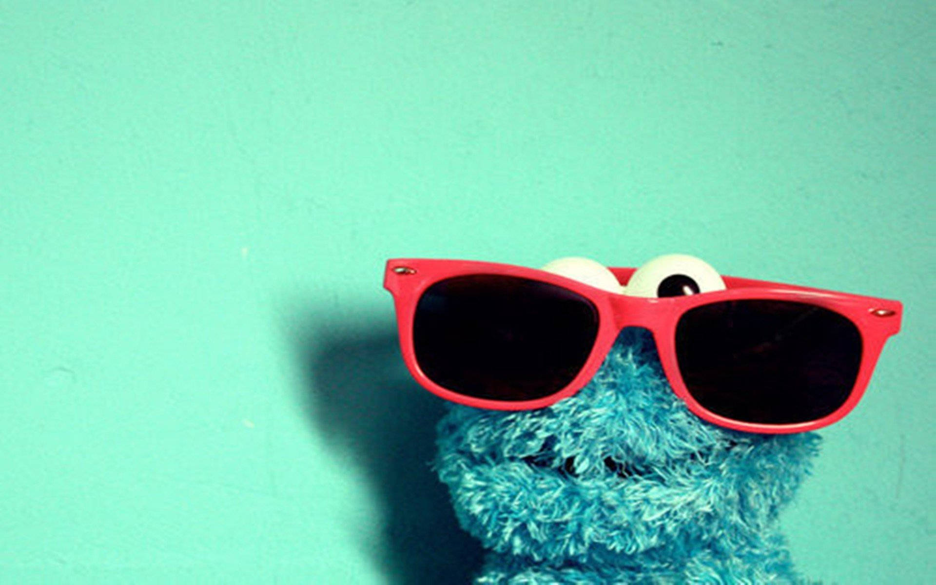 Cartoon Cookie Monster With Red Shades Background