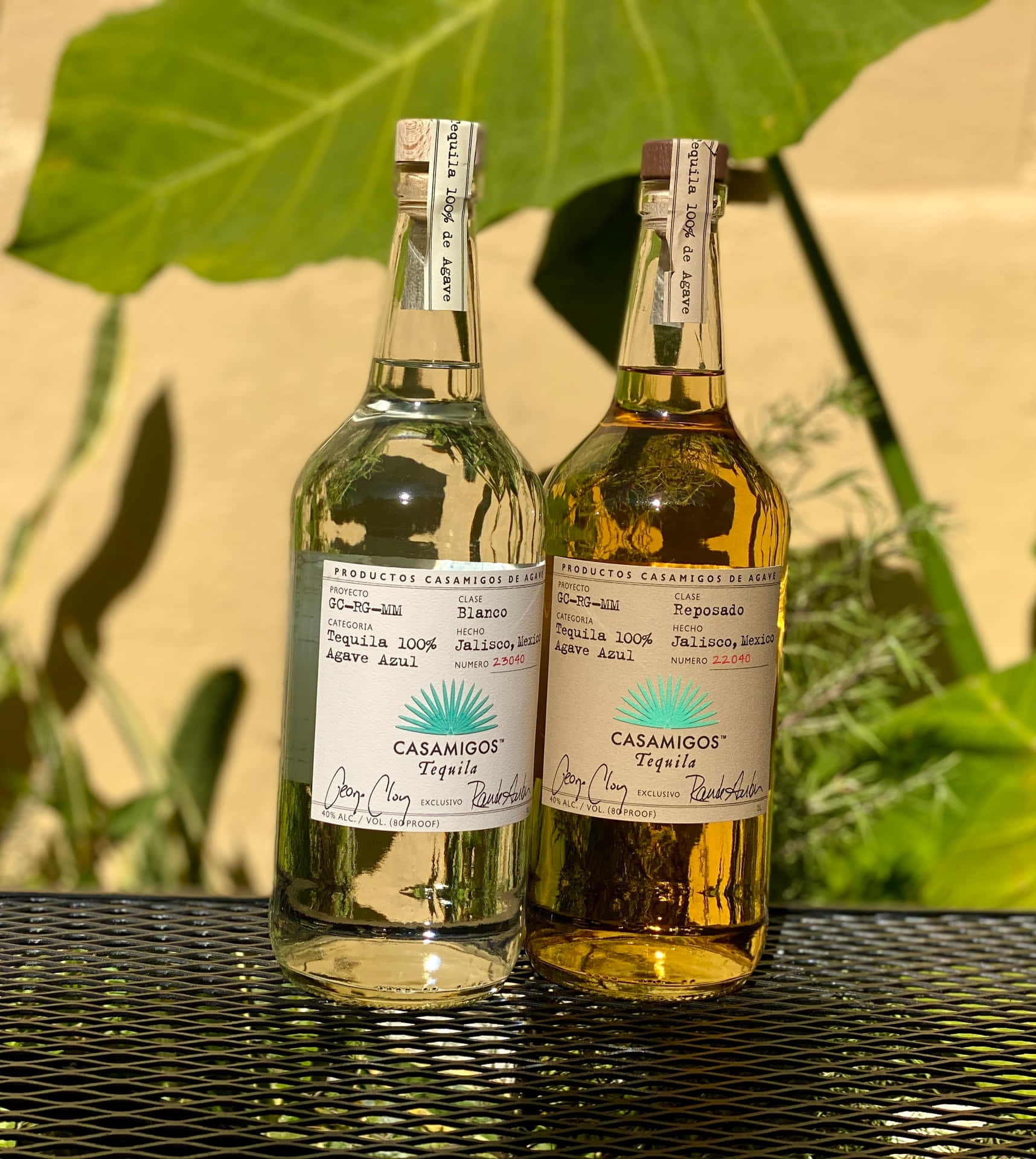 Casamigos Tequila Blanco And Reposado Liquor Bottles On Mesh Table