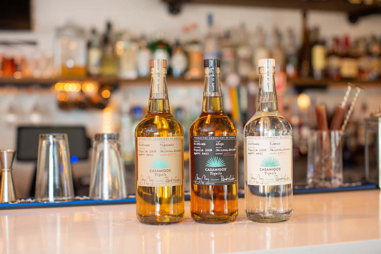 Casamigos Tequila Liquor Bottles On Bar Counter Background