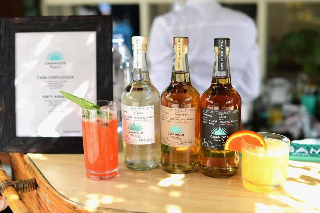 Casamigos Tequila Liquor Bottles On Outdoor Bar Counter Background