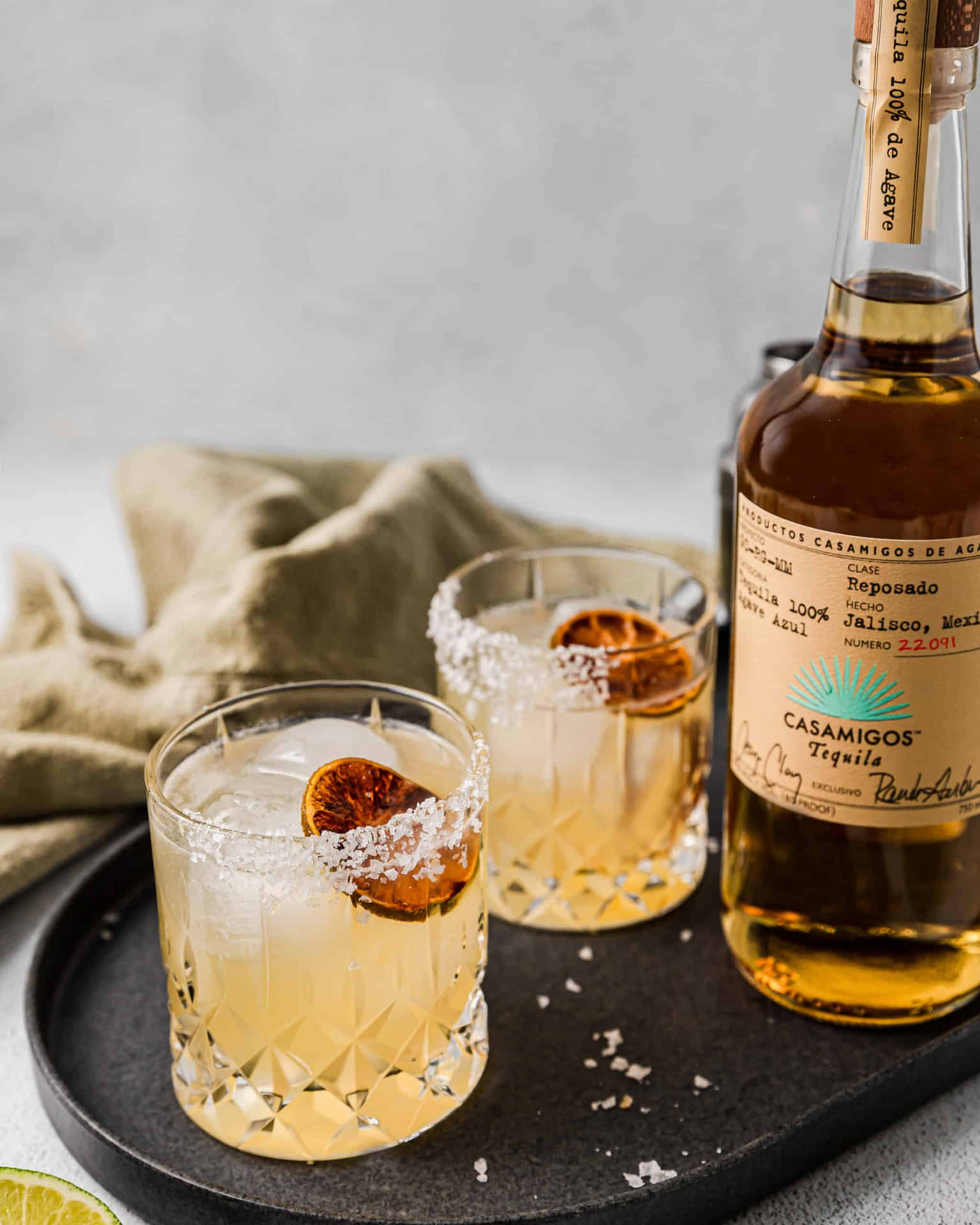 Casamigos Tequila Reposado Liquor Bottle And Margarita Drinks Background