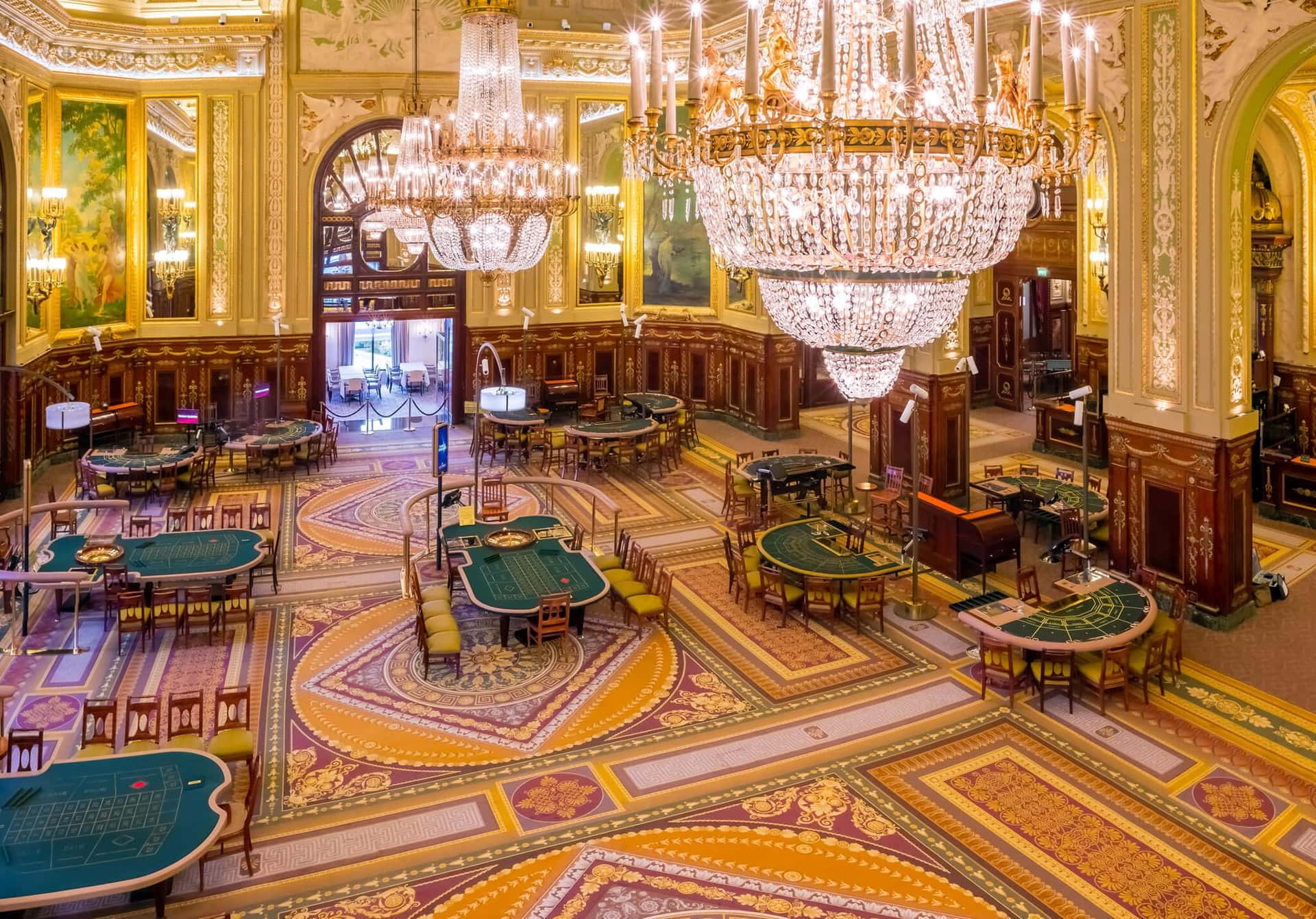 Casino De Monte Carlo Illuminating Chandeliers Background