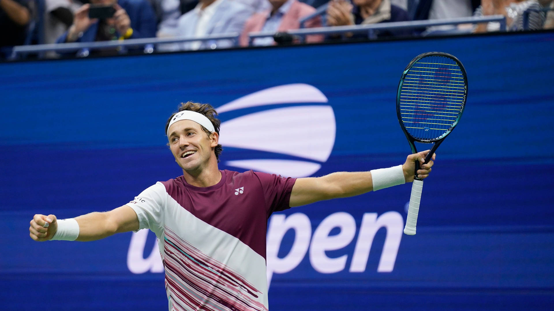 Casper Ruud Smiling While Holding Racket Background