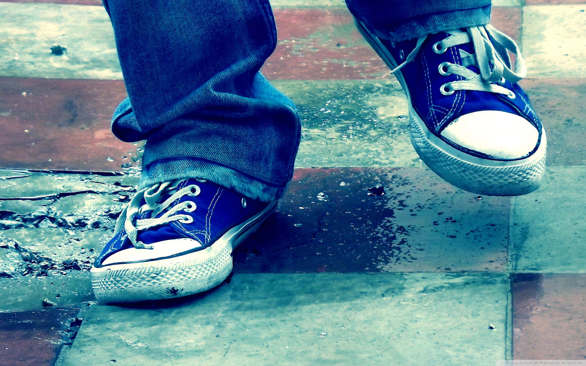 Casual Blue Sneakerson Wet Pavement Background