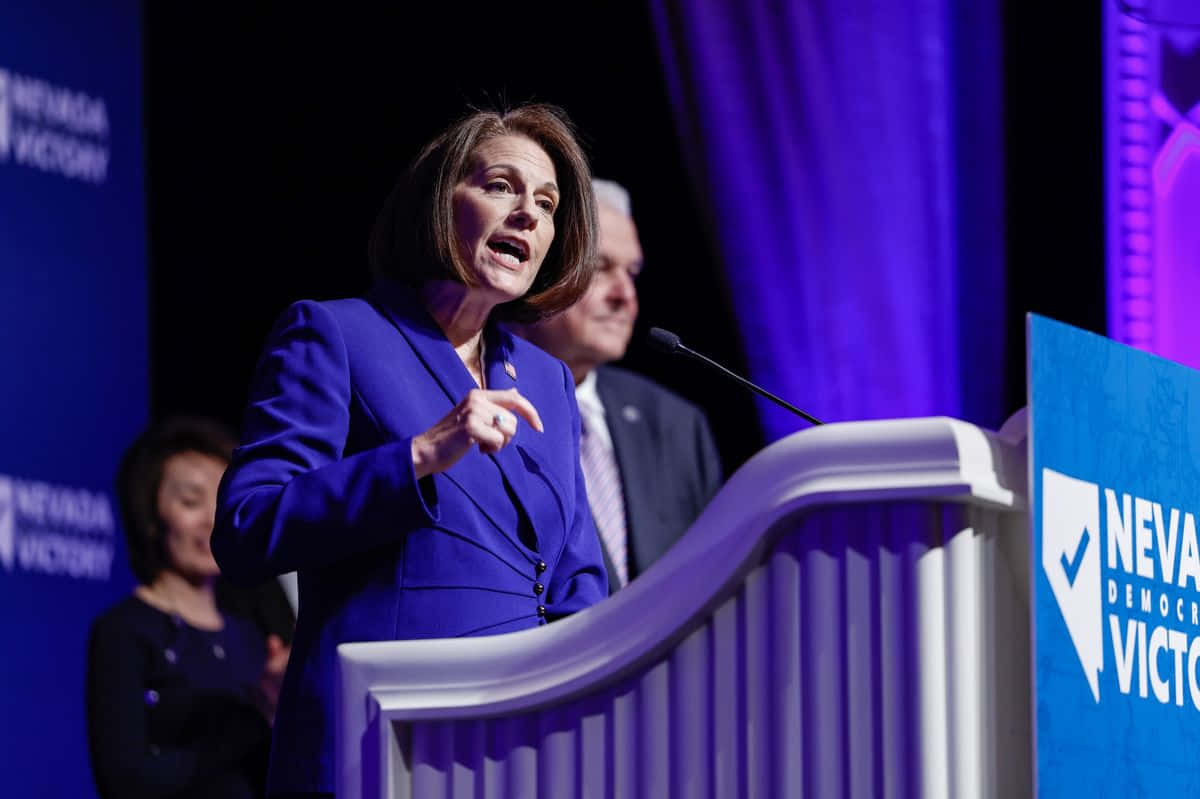 Catherine Cortez Masto Delivering A Keynote Speech Background