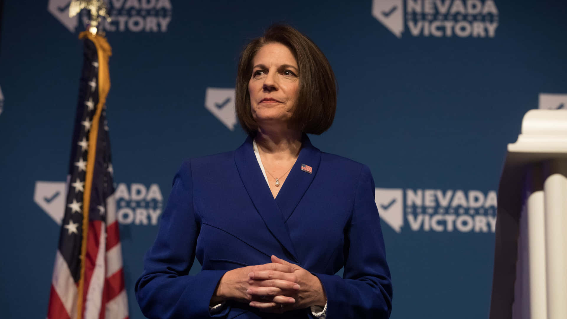 Catherine Cortez Masto Delivering A Speech At A Conference. Background