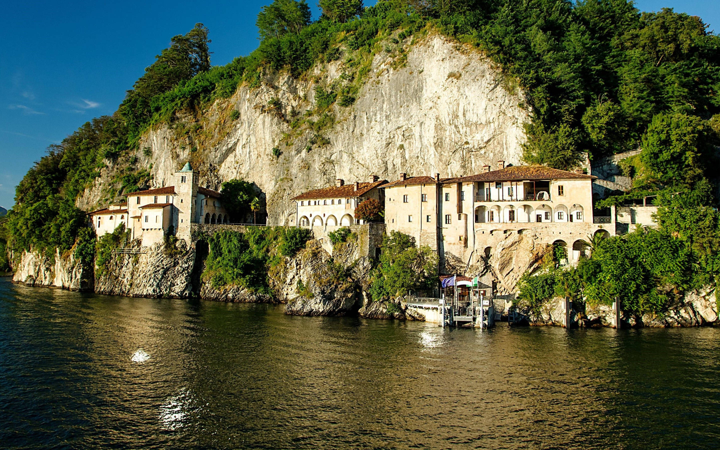 Catholic Monastery On A Cliff Background
