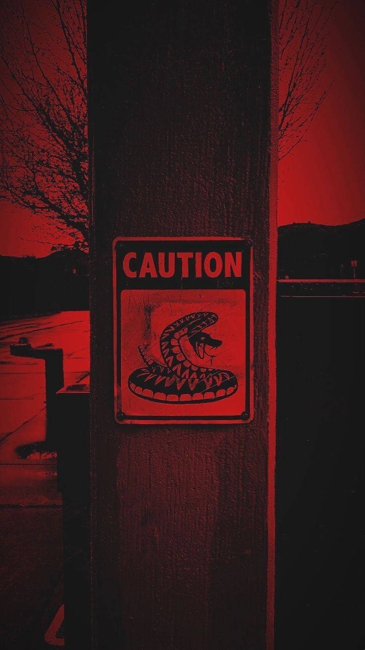 Caution Under Dark Red Sky Background