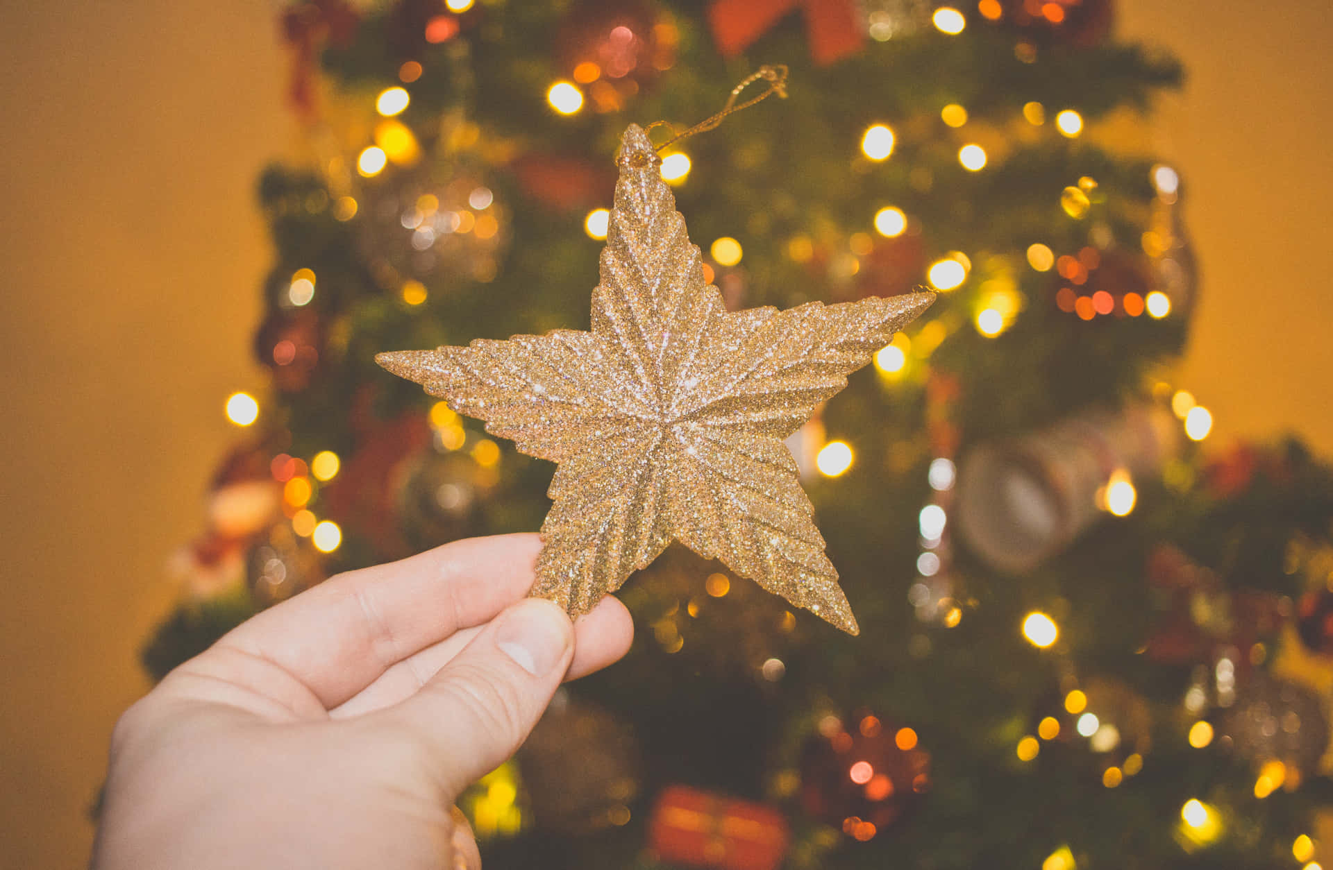 Celebrate A Memorable Christmas With A Festive Golden Decor Background