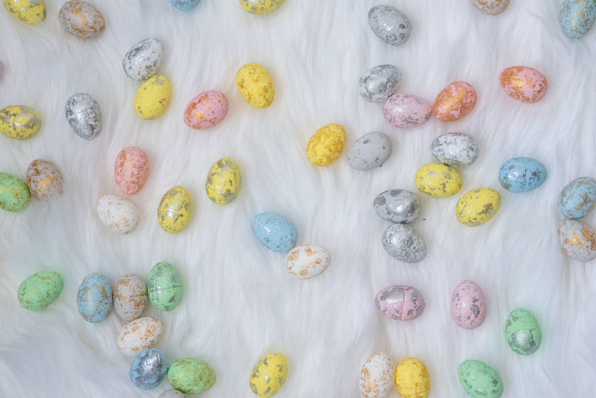 Celebrate The Joy Of Easter With Colorful Tiny Assorted Easter Eggs Background