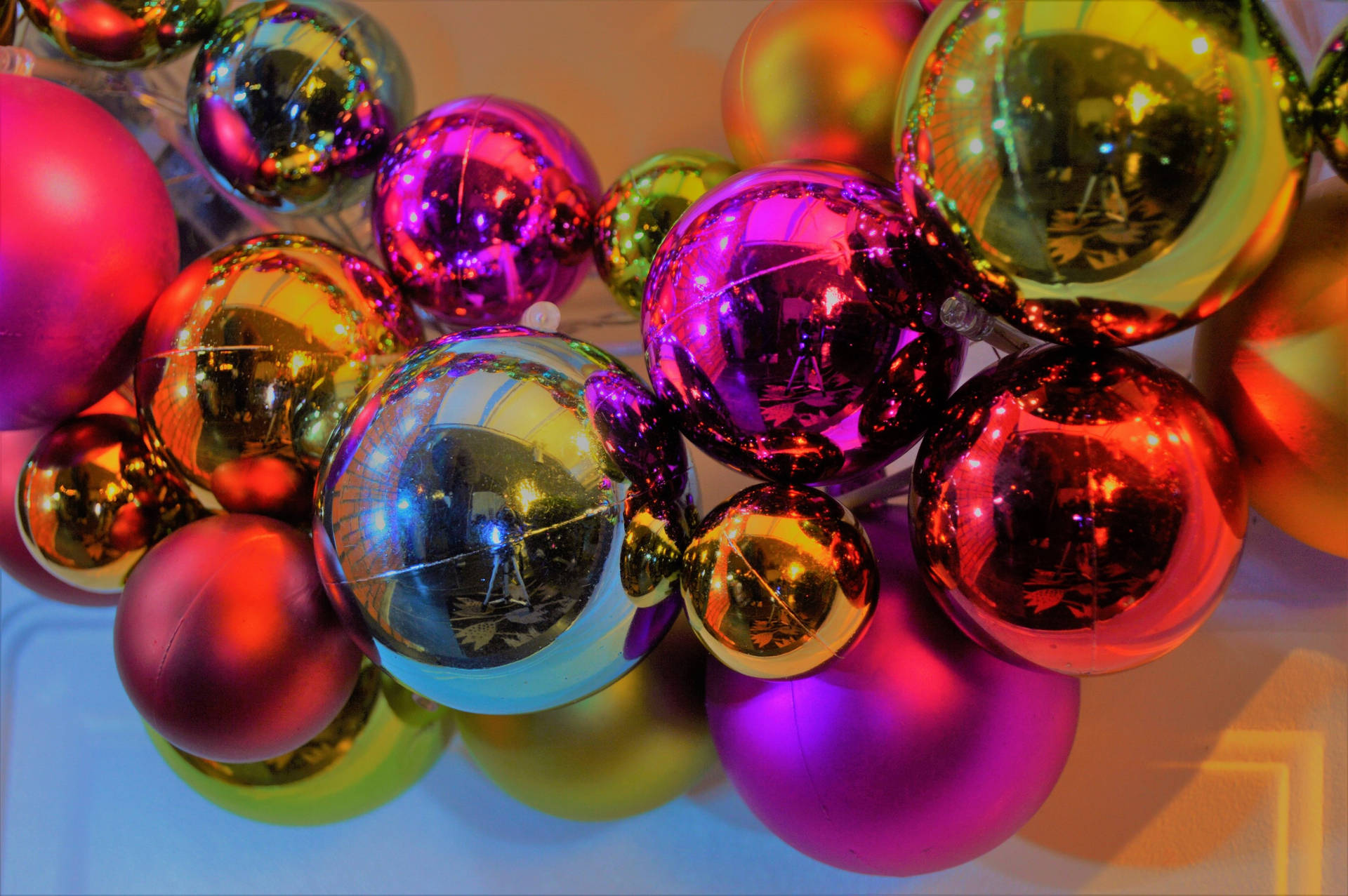 Celebrate The Joyous Season With Shiny Christmas Ornaments Background