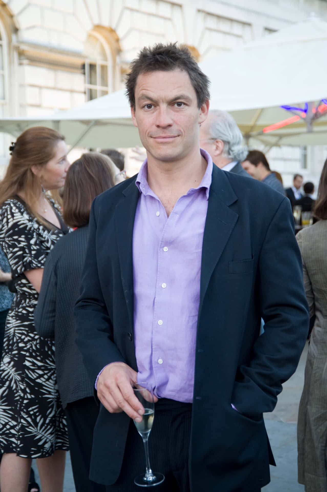 Celebrated Actor Dominic West Elegantly Posing For A Photoshoot. Background
