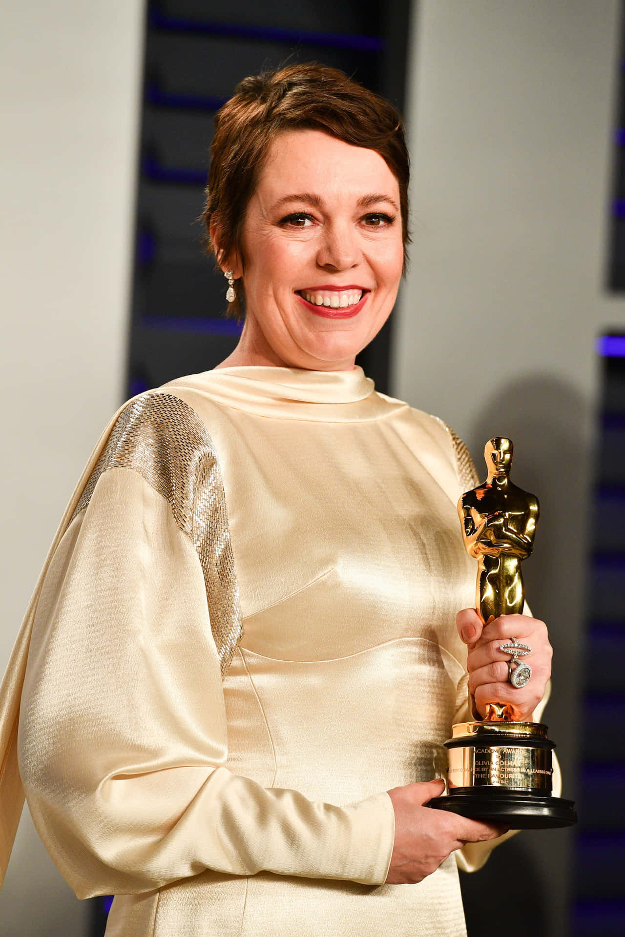 Celebrated Actress Olivia Colman Posing Charmingly. Background