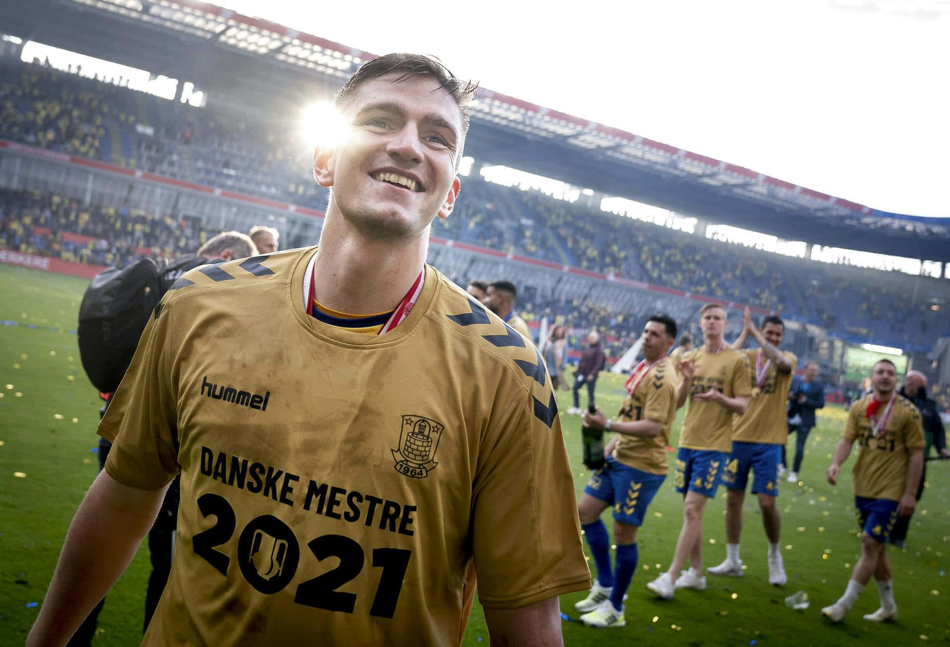 Celebratory Soccer Player Golden Moment Background