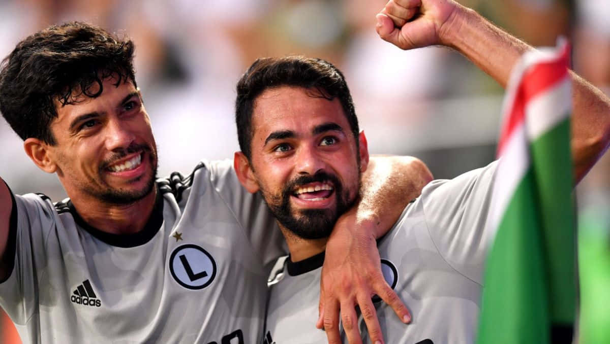 Celebratory Soccer Players Joyful Moment Background