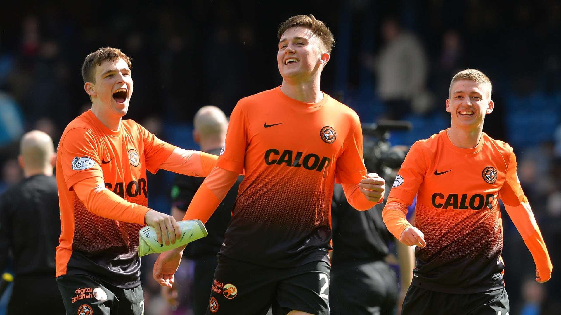 Celebratory Soccer Playersin Orange Jerseys Background