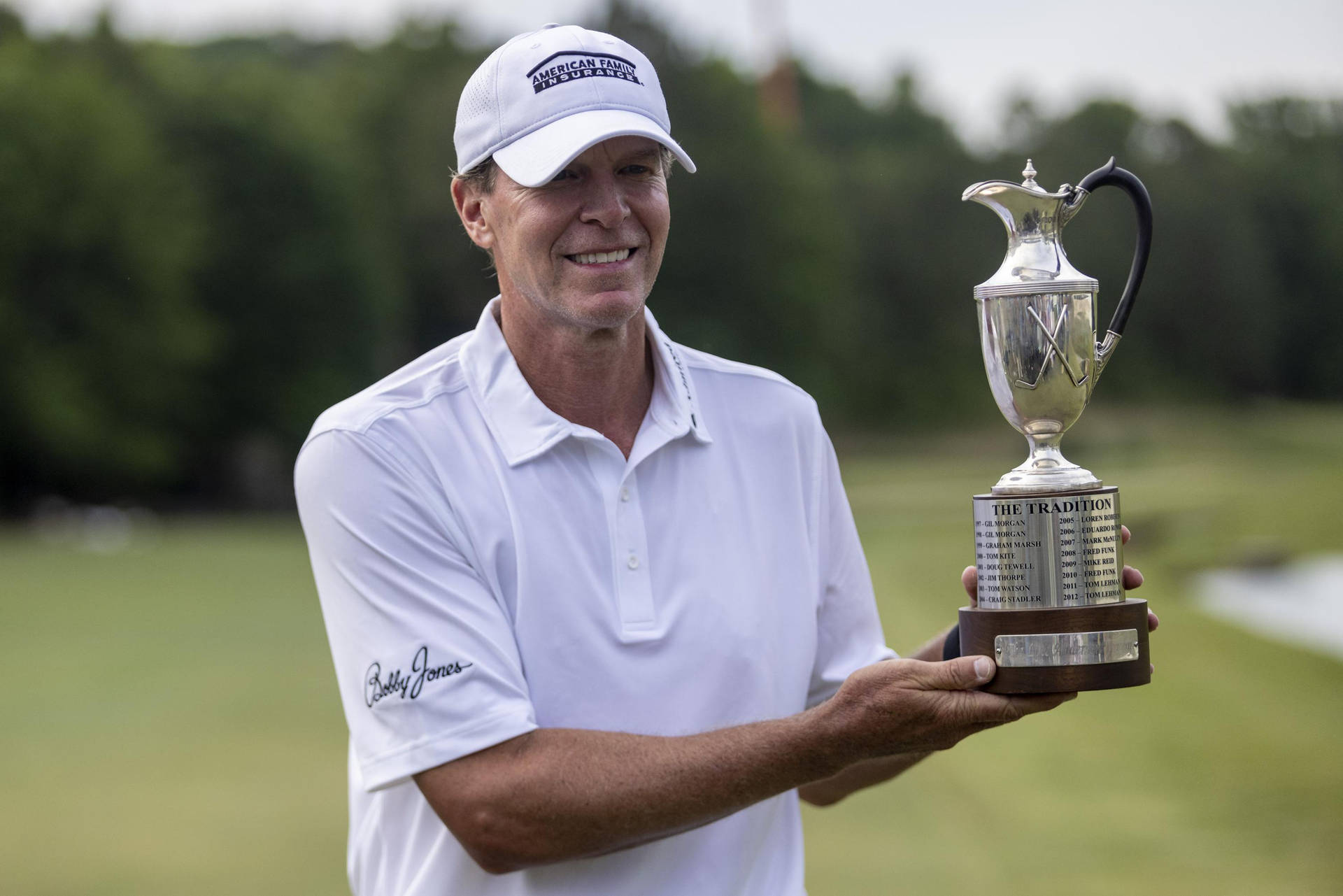 Champion Golfer Steve Stricker Holding His Trophy Background