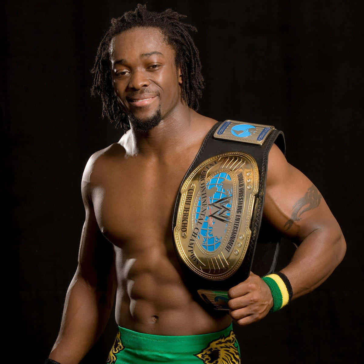 Champion Kofi Kingston Proudly Displays His Wwe Belt. Background