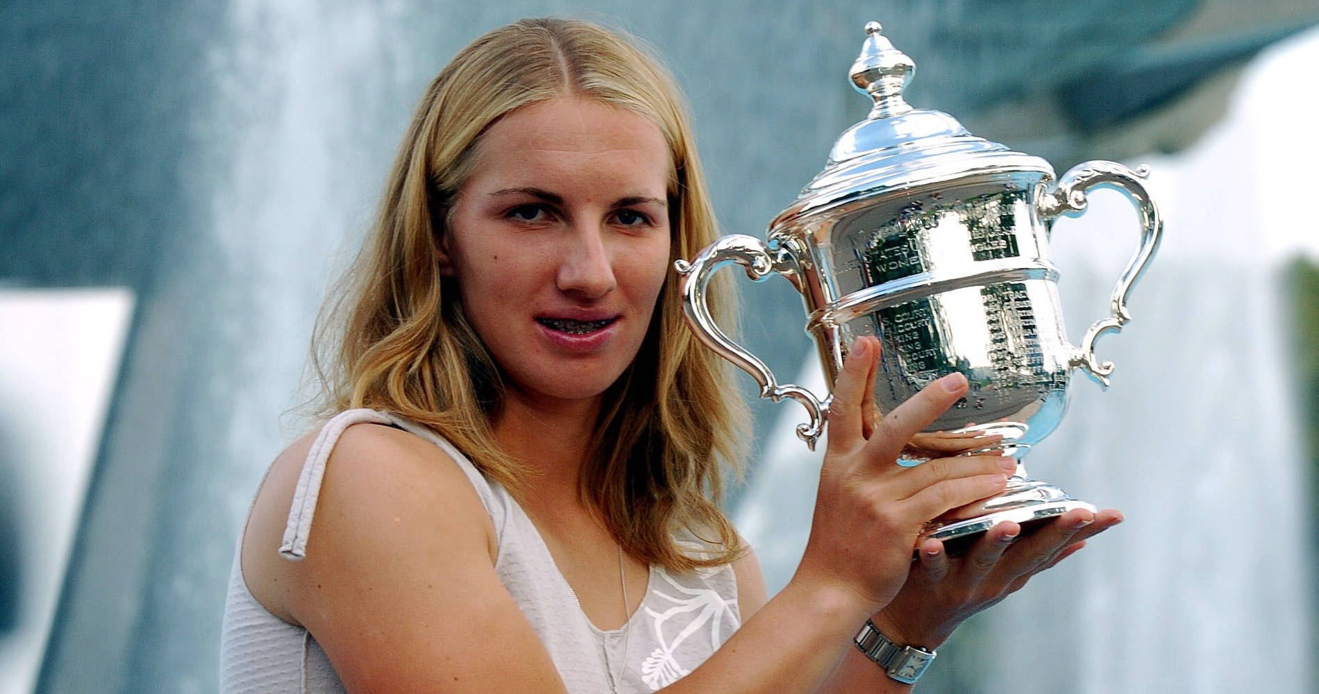 Champion Svetlana Kuznetsova Holding Up Her Trophy Background