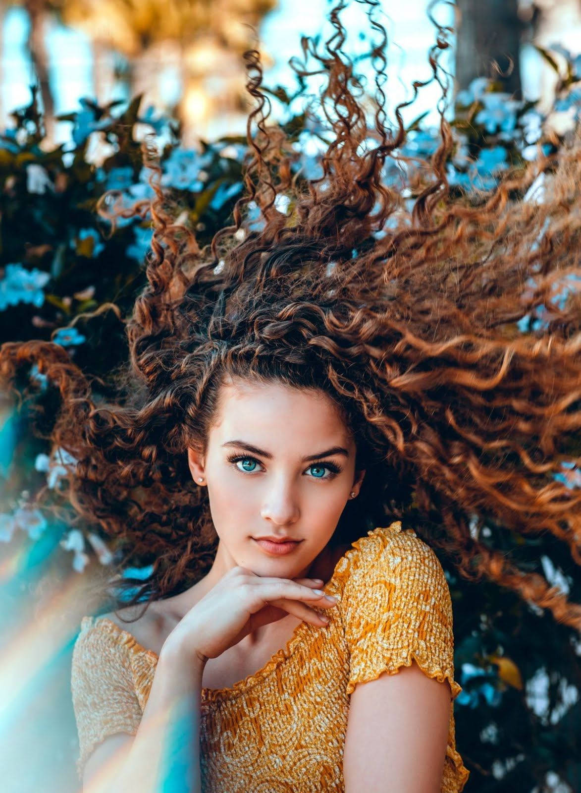 Charismatic Girl With Bountiful Curly Hair Background