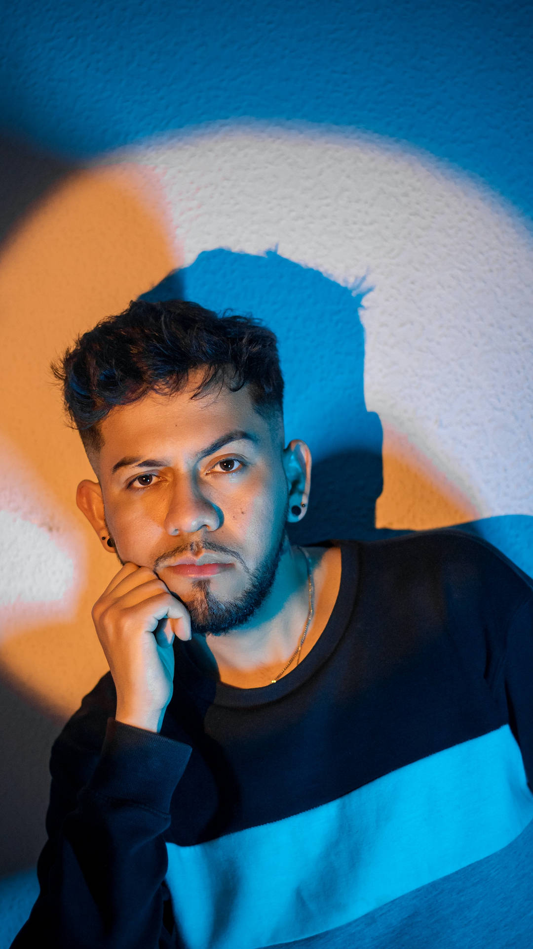 Charismatic Handsome Man Under Blue-orange Lighting Background