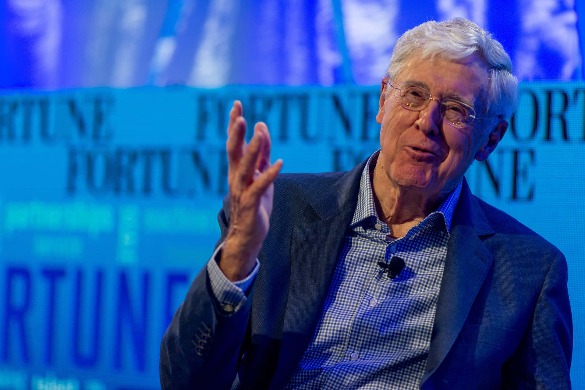 Charles G. Koch Communicating With Hand Gesture Background