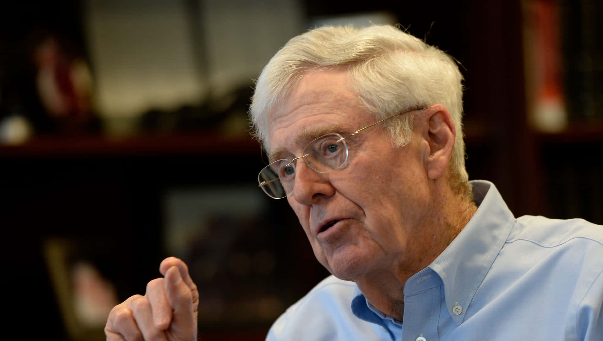 Charles G. Koch Making A Hand Gesture During A Speech Background